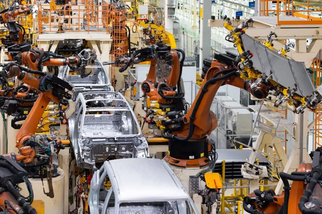 Car bodies are on assembly line. Factory for production of cars. Modern automotive industry. Top of