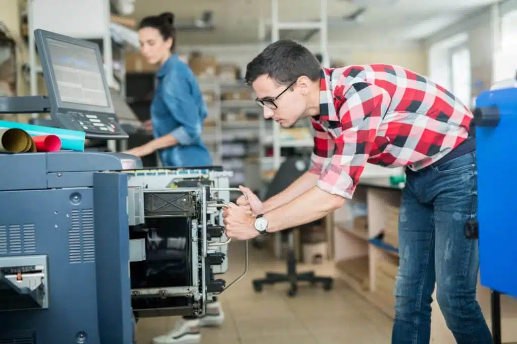 Man in typography working with printer
