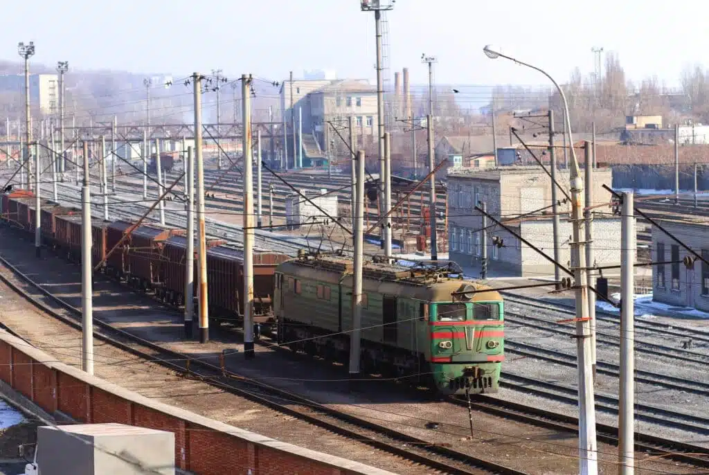 The only way to travel in the city. Shot of a train on the tracks with industry in the background.