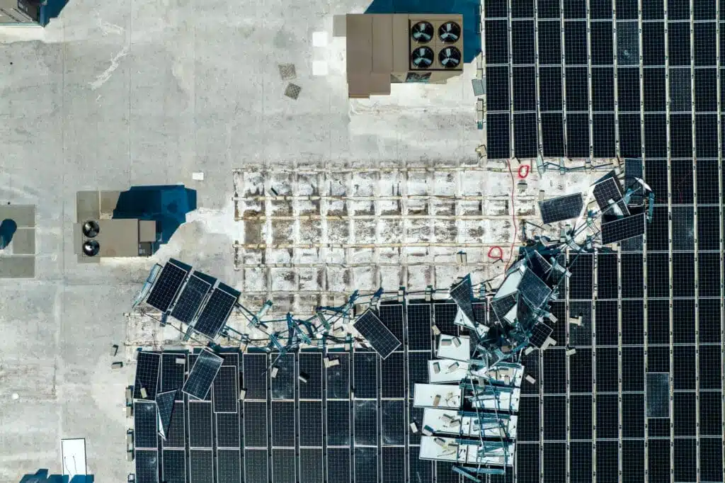 Aerial view of damaged by hurricane wind photovoltaic solar panels